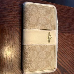 Tan and cream coach wallet.  Small pen mark (see pic). Lots of card storage.